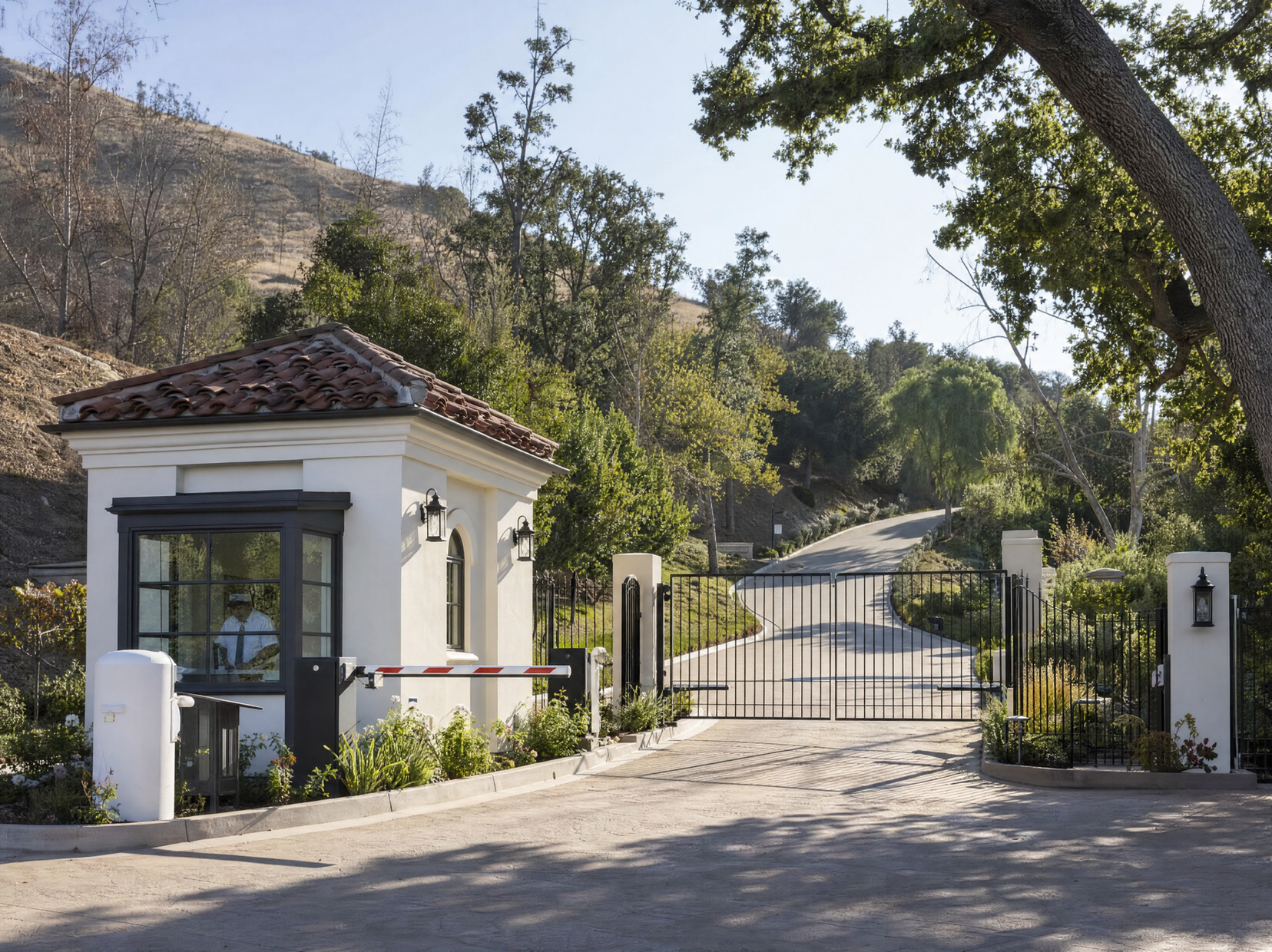 Staffed guard house and private gate at the entrance to a guard-gated community like those in Hidden Hills and Calabasas